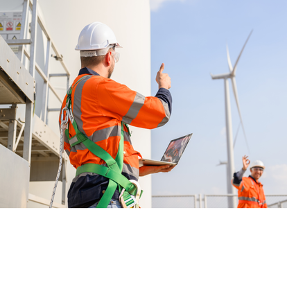 Zwei Techniker in Sicherheitskleidung und Schutzhelmen arbeiten an einer Windkraftanlage. Ein Techniker hält einen Laptop und zeigt einen Daumen hoch, während der andere im Hintergrund zurückwinkt.